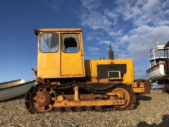 Yellow train on railroad track against sky