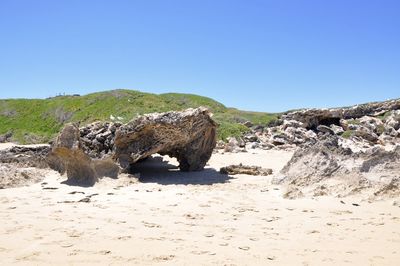 Scenic view of beach against clear blue sky