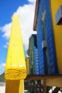 Close-up of yellow object against blue sky