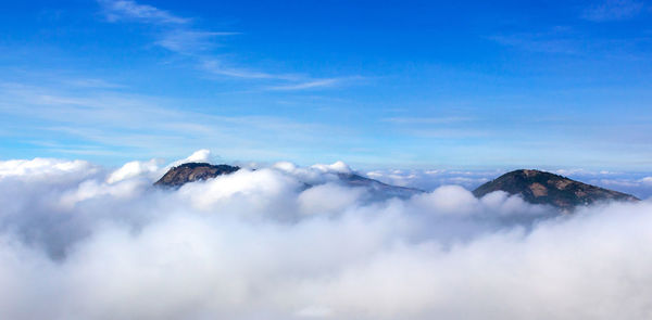 Scenic view of snowcapped mountains against blue sky