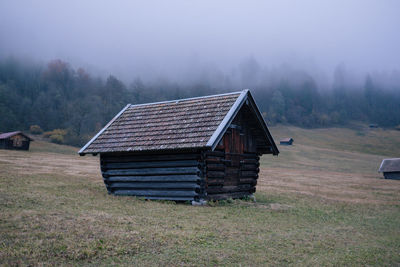 Lifeguard hut on field against sky