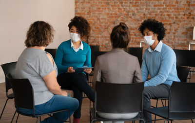 Group of people sitting on chair