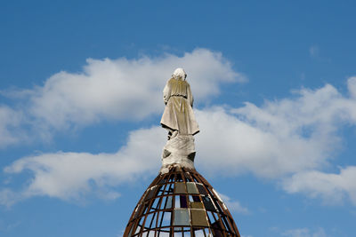 Low angle view of statue against blue sky