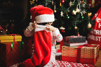 Cute girl holding christmas stocking