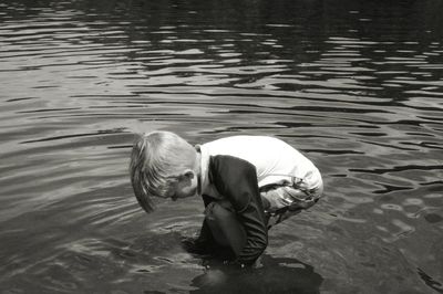Side view of boy playing in lake