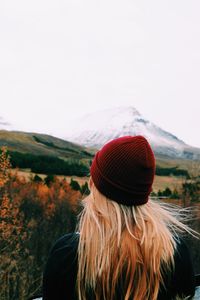 Rear view of woman wearing knit hat against clear sky