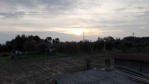 View of fields against cloudy sky