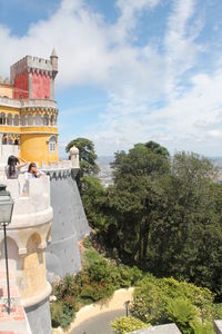 View of trees and buildings against sky