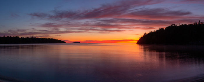 Scenic view of lake against romantic sky at sunset