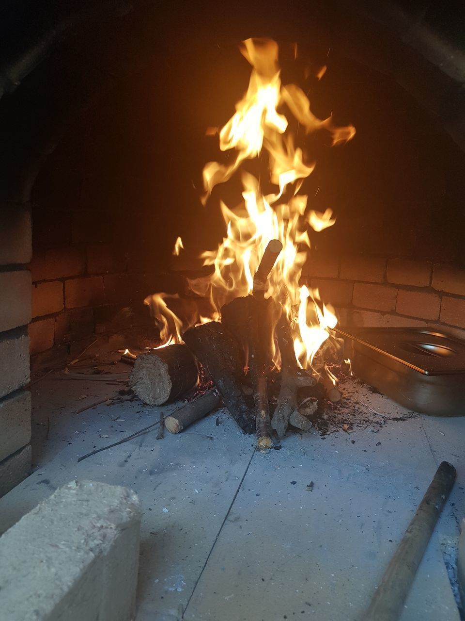 HIGH ANGLE VIEW OF FIRE BURNING IN THE DARK