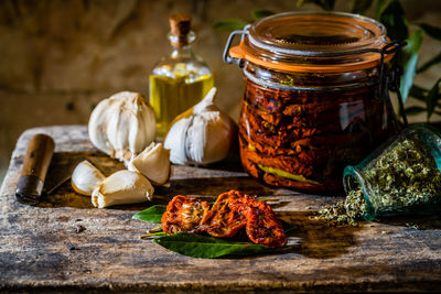 Close-up of dry tomatoes in jar on table