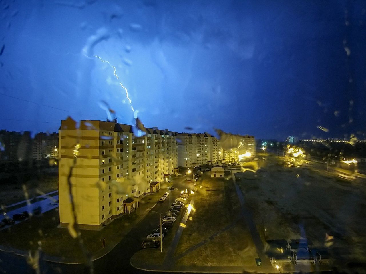 PANORAMIC VIEW OF ILLUMINATED CITY AT NIGHT