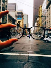 Close-up of person holding wet glasses