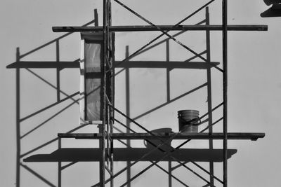 Paint can on scaffolding against wall