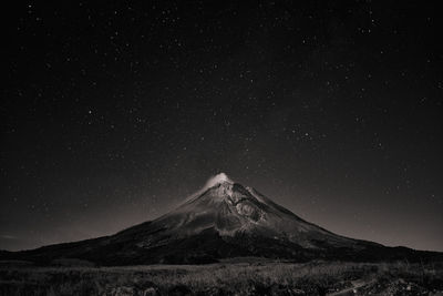 Scenic view of snowcapped mountains against sky at night
