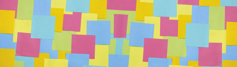 Multicolored sticky paper notes texture background, full frame