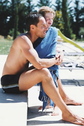 YOUNG COUPLE SITTING ON A MAN