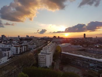 High angle view of road by buildings against sky during sunset