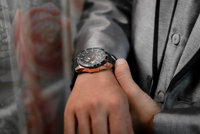 Midsection of man holding navigational compass