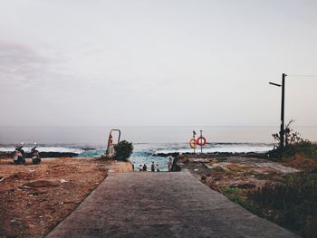 Road leading towards sea against sky