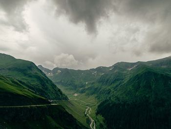 View of countryside landscape against cloudy sky