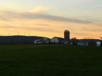 Built structure on field at sunset