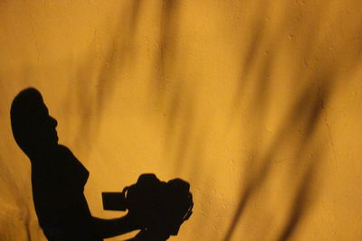 Silhouette of person shadow on hand