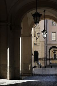 Illuminated street light on wall of building