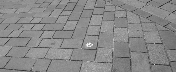 Panoramic view of cobbled street with symbol