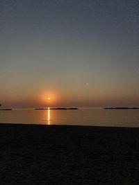 Scenic view of sea against clear sky during sunset