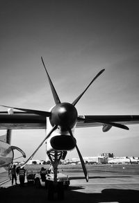 Cropped image of airplane on airport runway