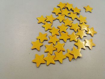 High angle view of yellow star shaped decoration on table