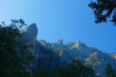 Low angle view of mountains against blue sky