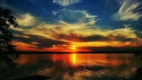 Reflection of clouds in sea at sunset