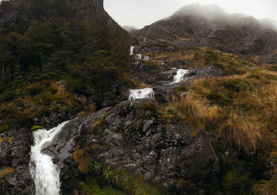 Scenic view of stream flowing through rocks