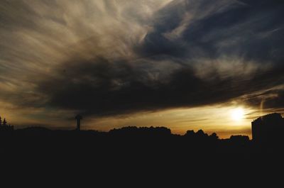 Silhouette of landscape against cloudy sky