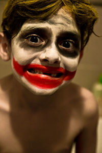 Portrait of shirtless boy with face paint