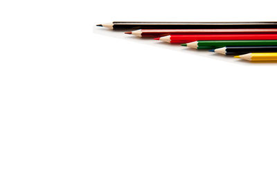 High angle view of multi colored pencils on white background