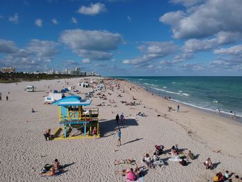 People on beach against sky