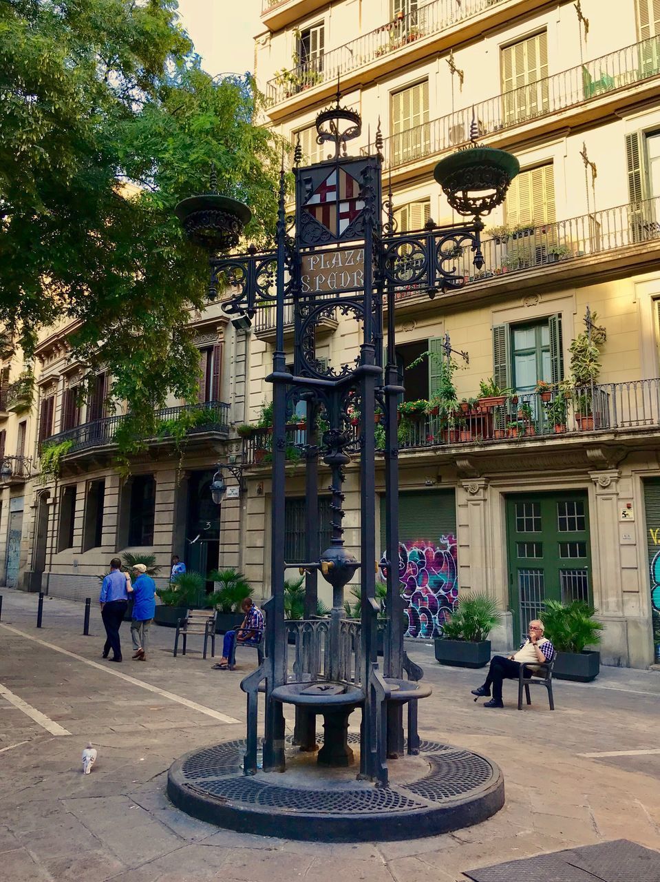 PEOPLE WALKING ON STREET BY BUILDINGS