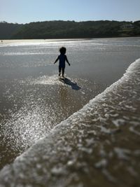 Full length of man in sea against sky