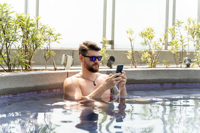 Portrait of young man in swimming pool