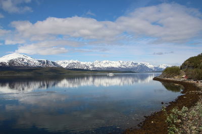 Scenic view of lake and mountains against sky during winter