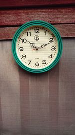 Clock mounted on plank at home