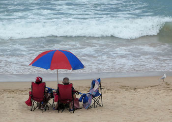 People sitting on chair at beach