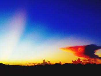 Scenic view of silhouette landscape against sky at sunset