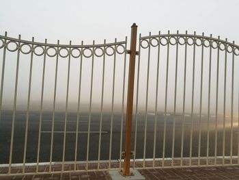Metal fence against sky