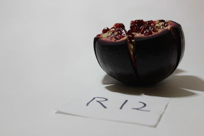 Close-up of cake on table against white background