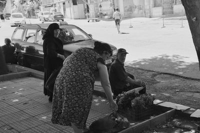 People on sidewalk in city