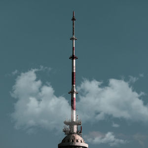 Low angle view of communications tower against sky